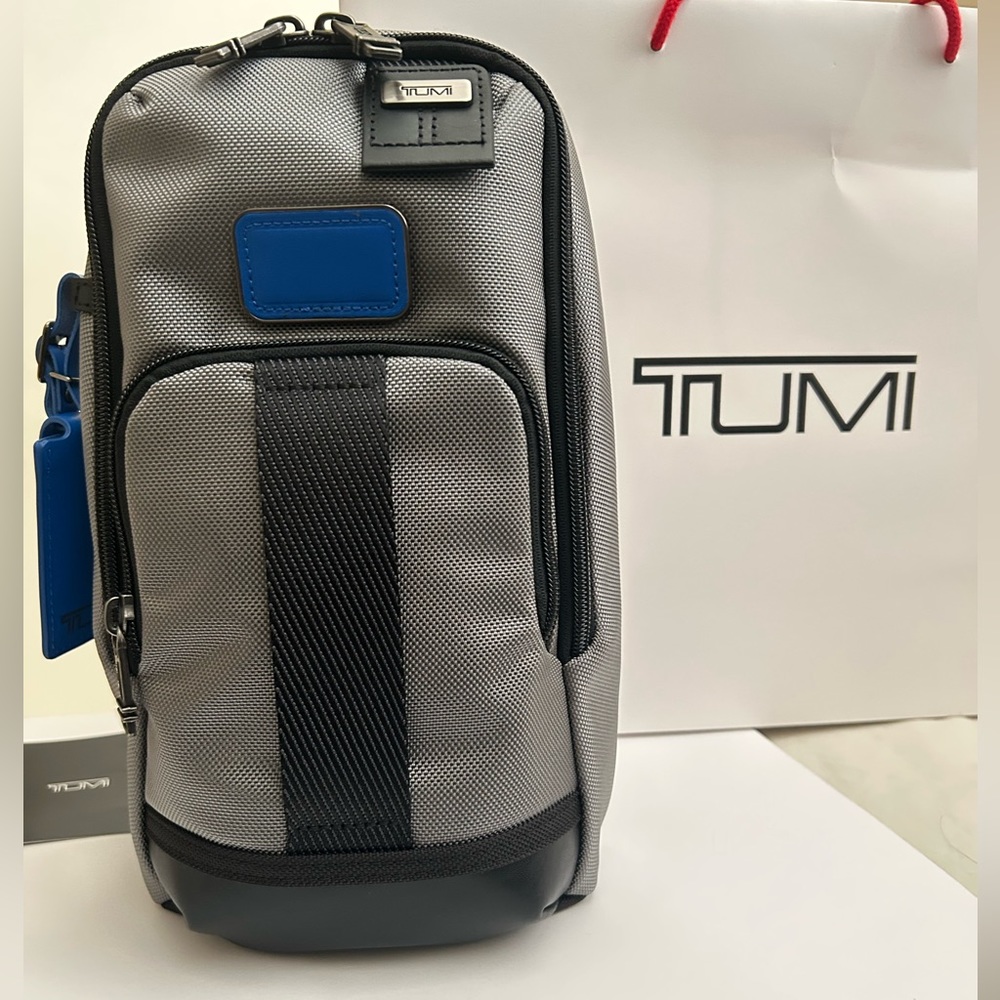 NWT TUMI FIFE SLIM SLING BAG
Dark gray with Blue tags